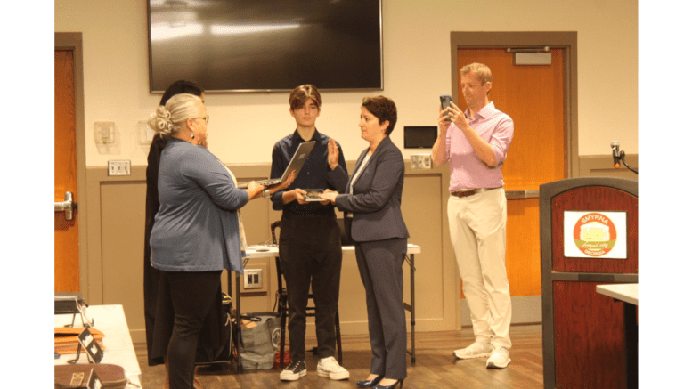 Kathy Young, surrounded by family, taking oath of office