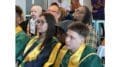 Several speakers offered advice to the grads in the audience. (Photo of three grads in audience)