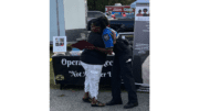 A resident hugs a police officer