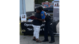 A resident hugs a police officer