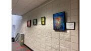 Paintings displayed on wall at Smyrna Community Center
