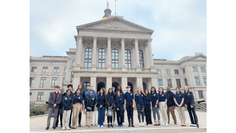 A group of high school students arranged for photo in front of the Georgia Capitol