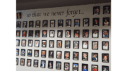 A wall of photographs of murder victims with the words "so that we never forget"