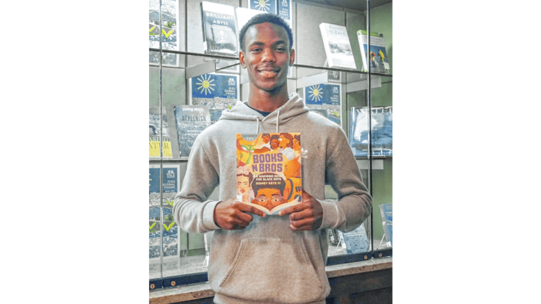 Sidney Keys III holds up book