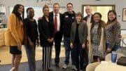 A group of people pose for a photo at the Pop-up Legal Clinic