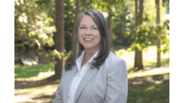 Susan Wilkinson in gray jacket standing outside