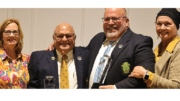 Eddie Canon and Jimmy Gisi in suits, smiling, flanked by two women