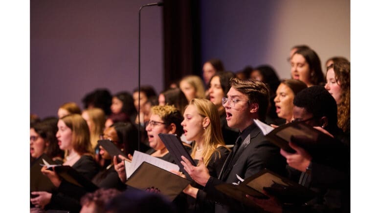 A diverse young group of college singers in concert