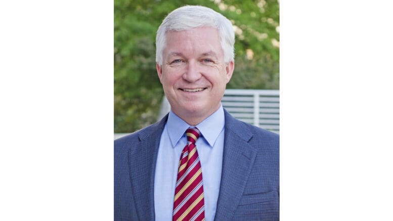 Dr. Joe Thompson in suit and tie smiling