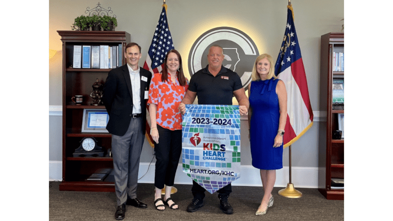 Cobb school Superintendent Chris Ragsdale holds American Heart Association Kids Heart Challege banner