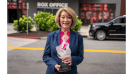 Rhonda Jacobson holding her "Woman of Distinction" award