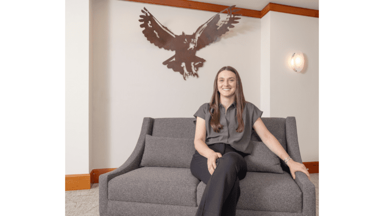 Artist on sofa with her Owl sculpture above her