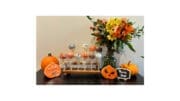 A whimsical Halloween arrangement of candies on sticks, most of them shaped like jack-o-lanterns