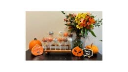 A whimsical Halloween arrangement of candies on sticks, most of them shaped like jack-o-lanterns