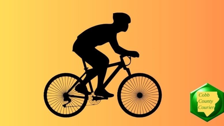 A silhouette of a cyclist riding a road bike