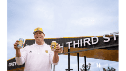 Man wearing a KSU cap holding a beer can with KSU branding