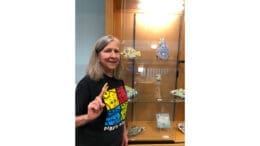 Karen Fincannon stands in front of her display case of ceramic art