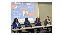 L-r Vickie Benson, Leroy Tre’ Hutchins, Laura Judge, Andrew Cole seated at a table in front of the Cobb school board candidates forum