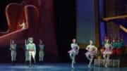 Atlanta Ballet performs The Nutcracker -- wooden soldiers are featured on the left, three female dancers on the right