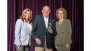 John Shern receives Cumberland Citizen of the Year flanked by two women officials of the Cobb Chamber