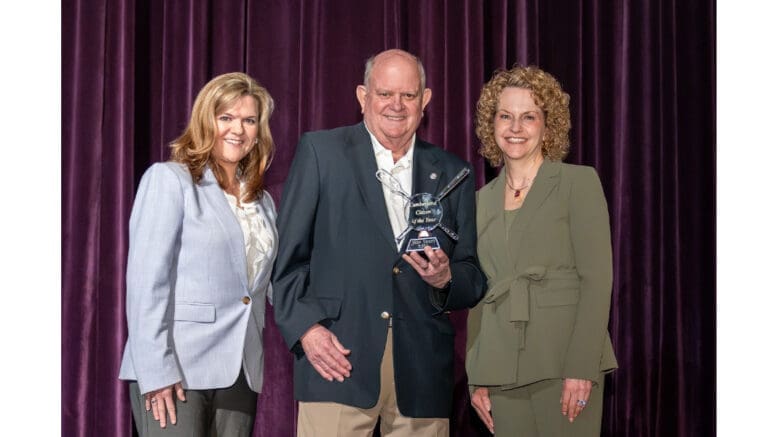 John Shern receives Cumberland Citizen of the Year flanked by two women officials of the Cobb Chamber