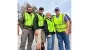 Four volunteers in yellow safety vests in group photo for Friends of Socktown litter cleanup