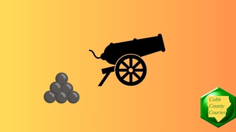 Silhouette of a cannon on wheels beside a pyramid of cannon balls