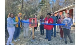 Ribbon-cutting for Little Free Library on Quintasha Swanson's property