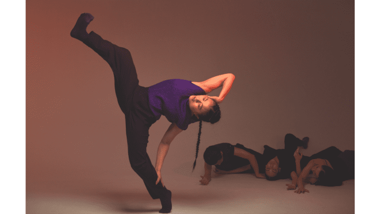 A young woman from Anne Plamondon Productions dancing, leaning back on one leg with an arm behind her head