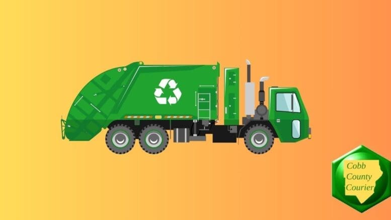 A green recycling truck driving down the street