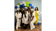 Young women in white graduation caps and gowns