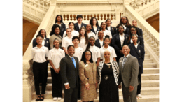 Elected officials and students at the Georgia capitol building interior stairs in group photo