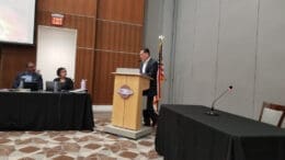 Rausch Advisory Services CEO Michael Harrington speaks to the Mableton City Council, council members TJ Ferguson and Debora Herndon look on