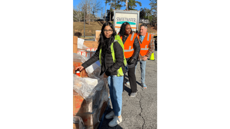 Volunteers at Sweetwater Mission's food distribution at Waverly Trailer Park hand out food