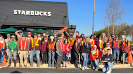 A large group of volunteers in front of a Starbucks prior to the Chattahoochee RiverLands river cleanup