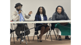 Cobb school board member Leroy Tre’ Hutchins, Ty’Sheka Lambert of Georgia CAN, and moderator China Cardriche-Clements sit at a table at an education forum, Hutchins with hand-held microphone