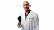 Dr. Bharat Baruah holds a piece of transparent wood