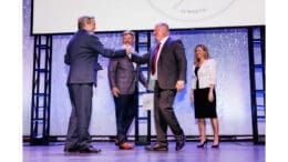Owner of 1885 Grill receiving Small Business of the Year award onstage