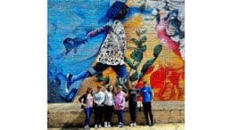 Photo of volunteers at a art installation for the Mountain to River Trailfest