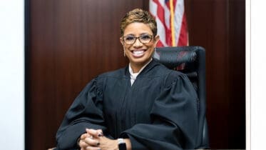 Judge Sonja Brown, smiling, seated in robes
