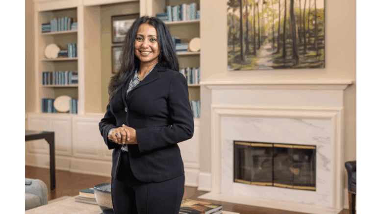 Sweta Sneha, standing,wearing a dark suit