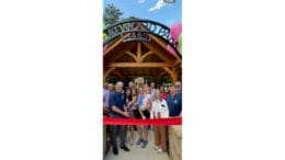 Group photo of residents in front of ribbon at Creatwood Park during opening ceremony