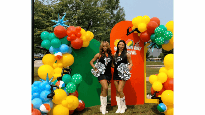 Two sheerleaders with Falcons emblems