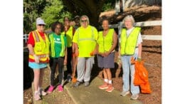 Group shot of people at litter cleanup wearing safety vests