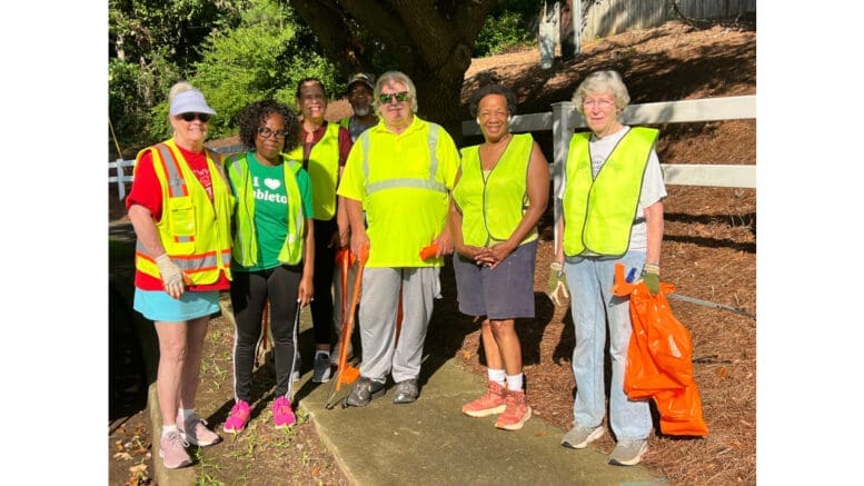 Group shot of people at litter cleanup wearing safety vests