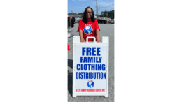 Carolyn Turner, President and CEO of HOPE Family Resource Center standing behind clothing drive sign