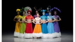 A row of ballet dancers in colorful costumes from the Atlanta Ballet's production of Frida