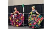 Two dancers in colorful costumes