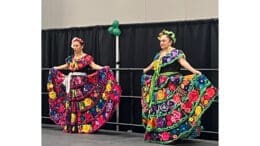 Two dancers in colorful costumes