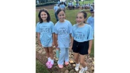 Three children wearing Whitefield Academy Great Day of Service t-shirts